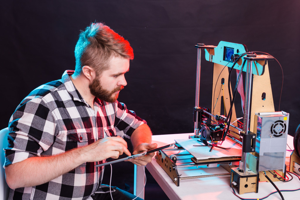 A person utilizing a 3D printing machine