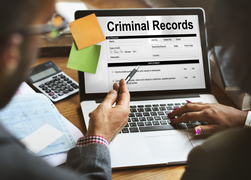An employer checking criminal record on laptop