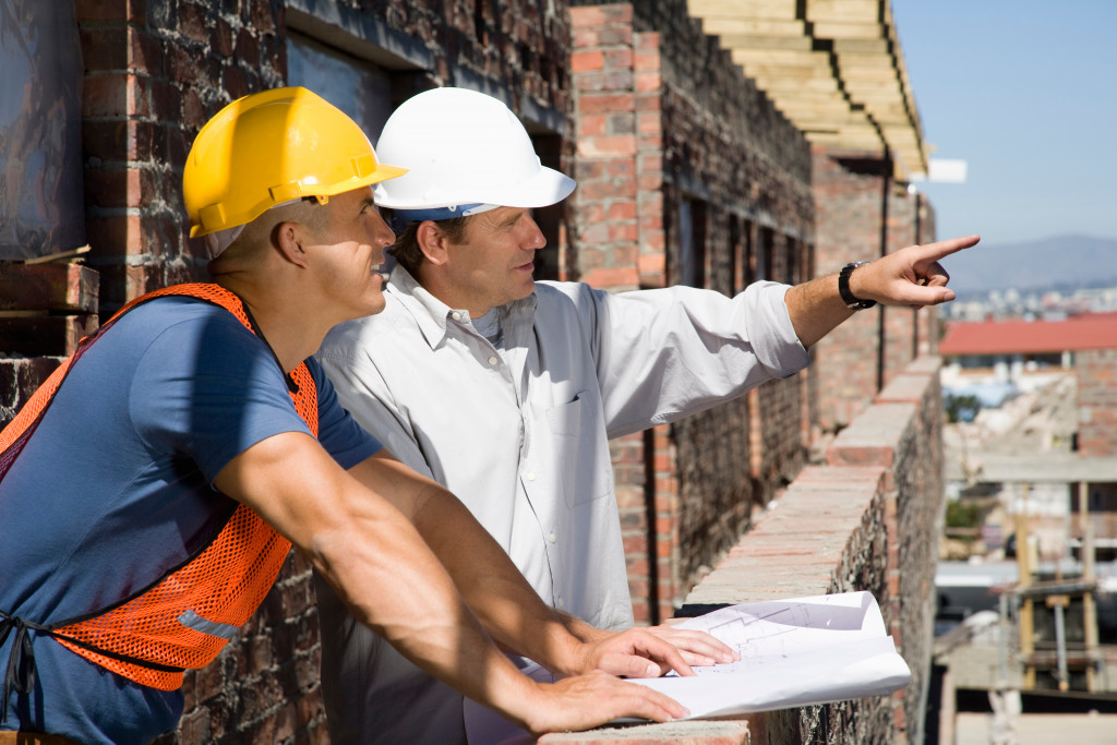 A construction businessman pointing while another looks